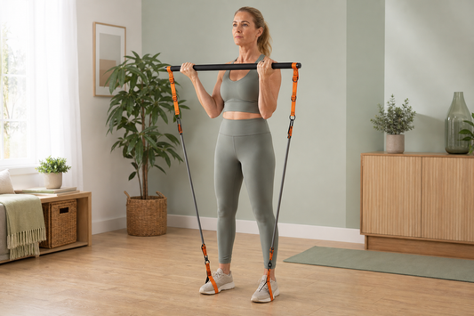 Woman using orange Pilates bar at home